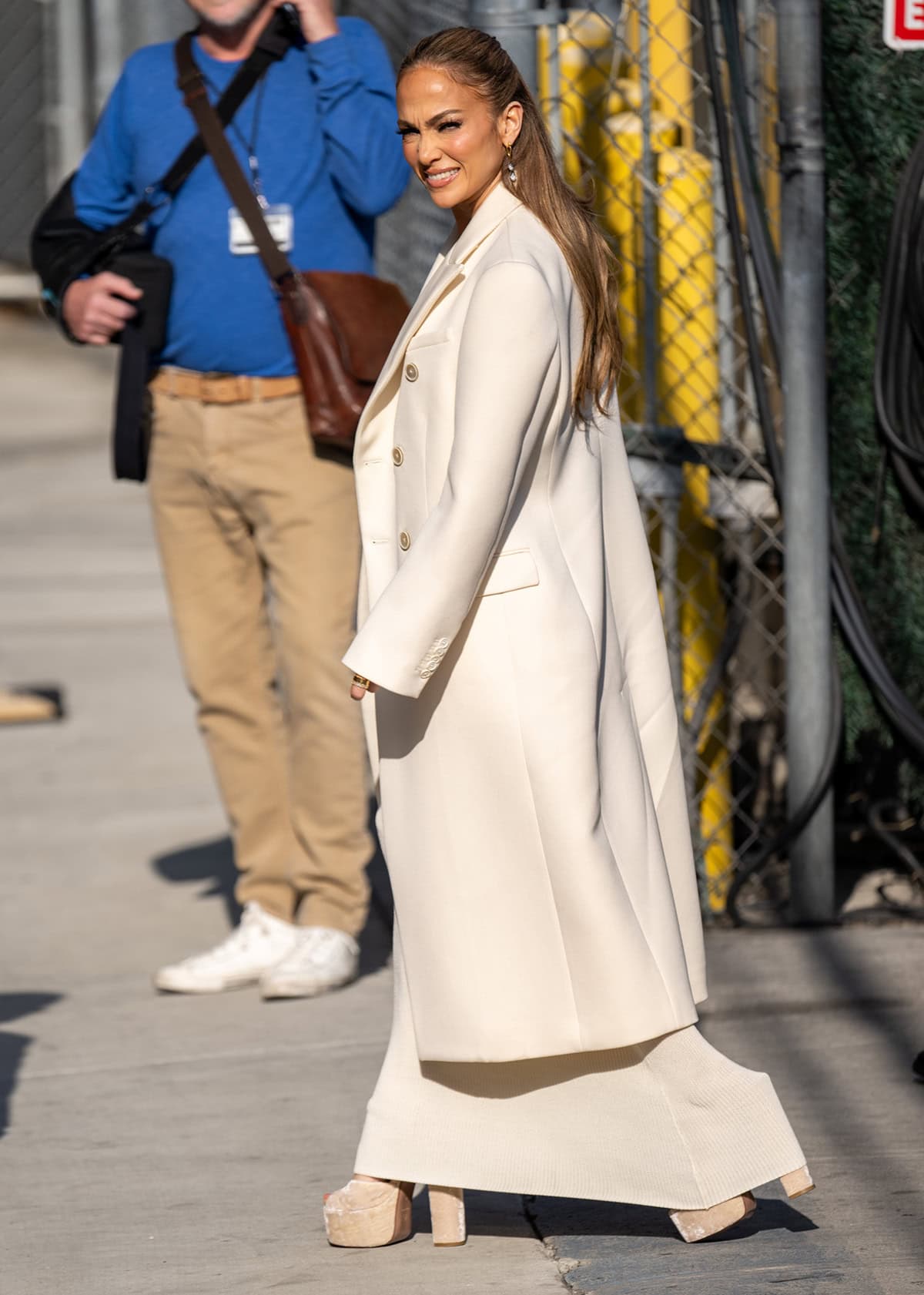 Jennifer Lopez drops by Jimmy Kimmel Live studios in a cream-colored dress, coat, and platform sandals to discuss her Netflix movie Atlas