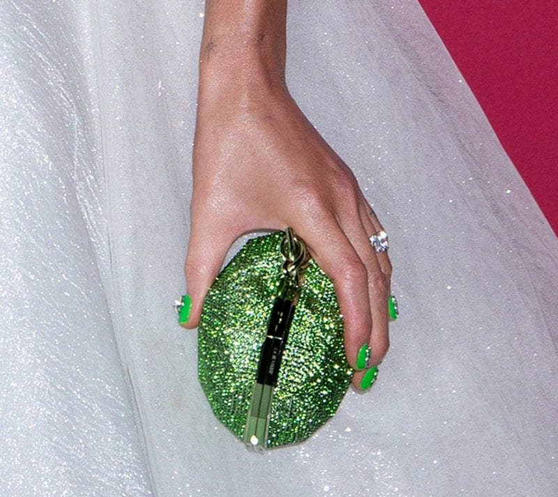 Kate Beckinsale adds a pop of color to her white bridal look with green nail art and a sparkling green crystal-embellished Jimmy Choo clutch