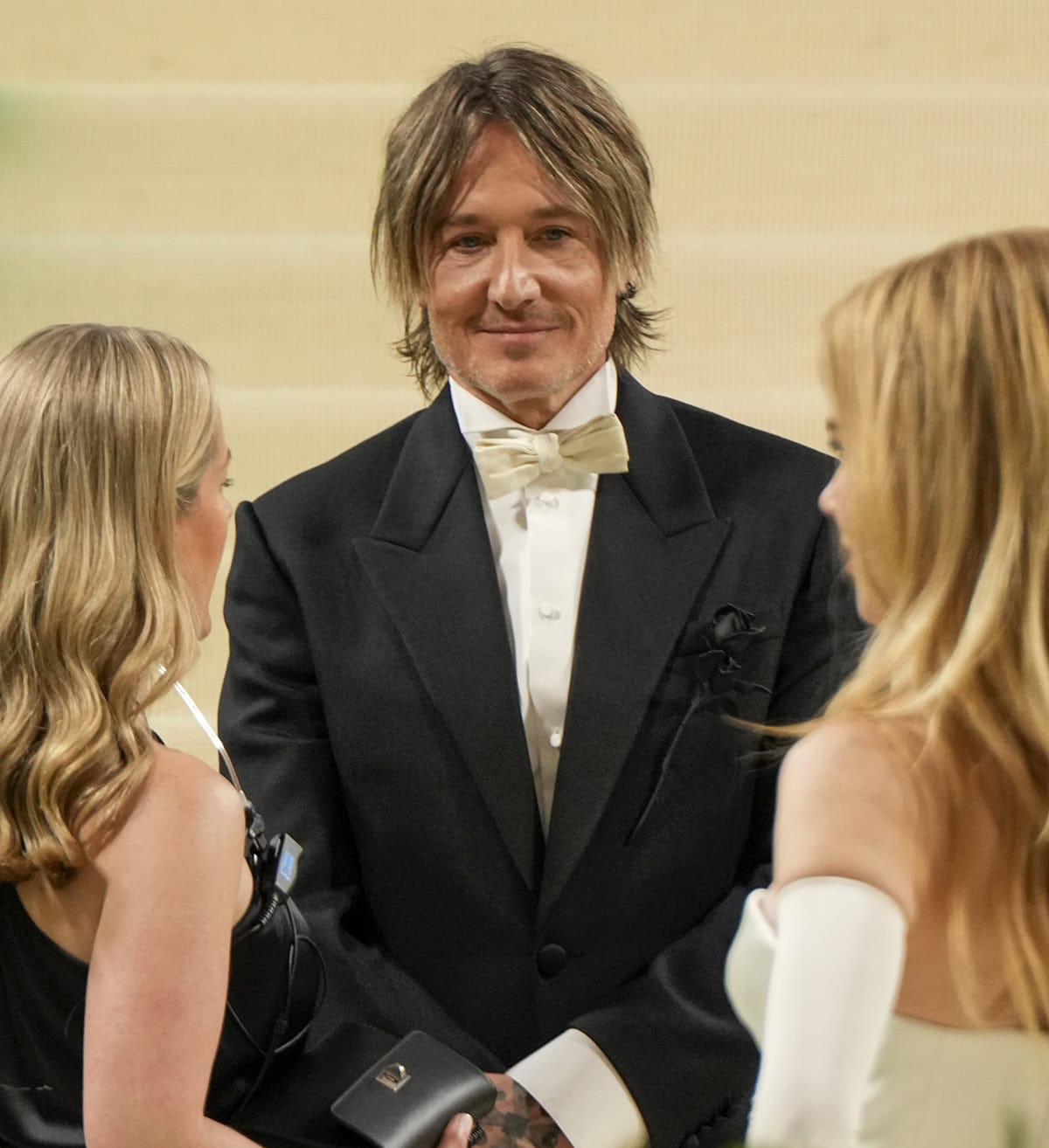 Keith Urban complements his wife in a black-and-white tuxedo suit with a black rose as a nod to the evening's theme