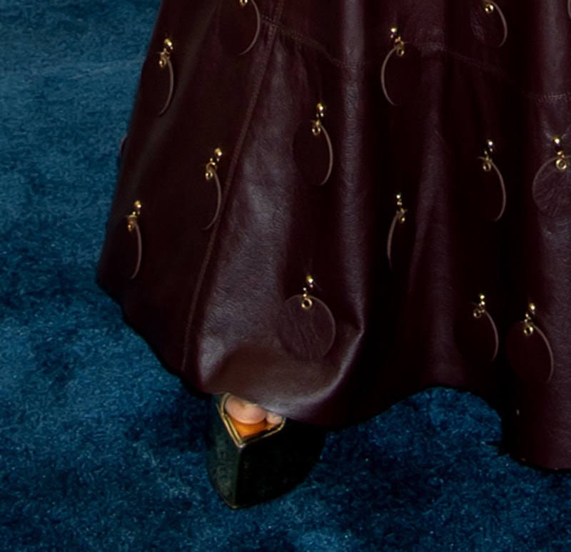 Kerry Washington teams her burgundy leather dress with metallic gold platform sandals by Alexandre Vauthier