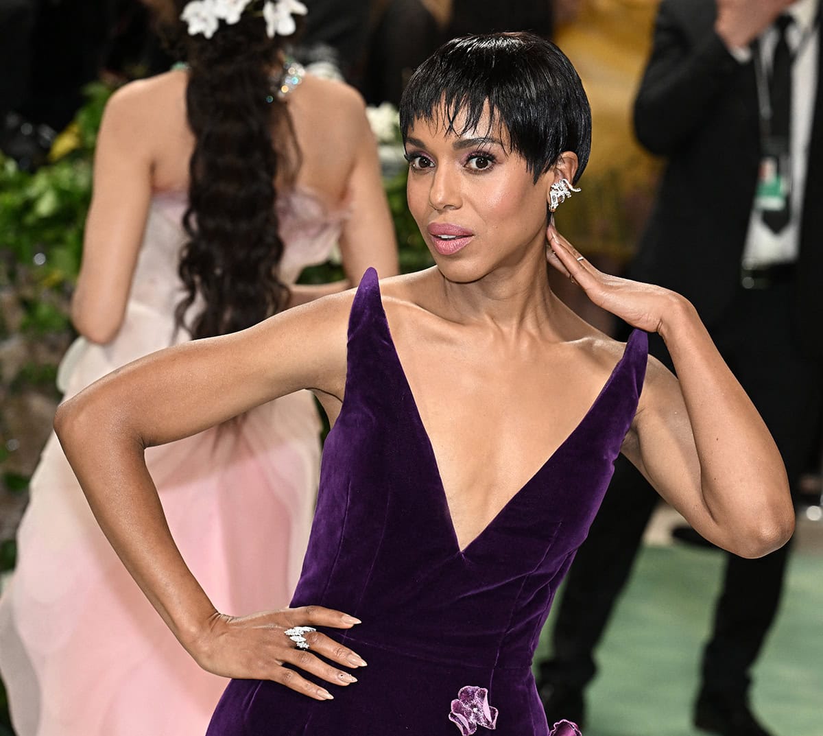 Kerry Washington styles her purple gown with diamond jewelry by Yeprem and wears mauve eyeshadow and a wet-look pixie hairstyle with baby bangs