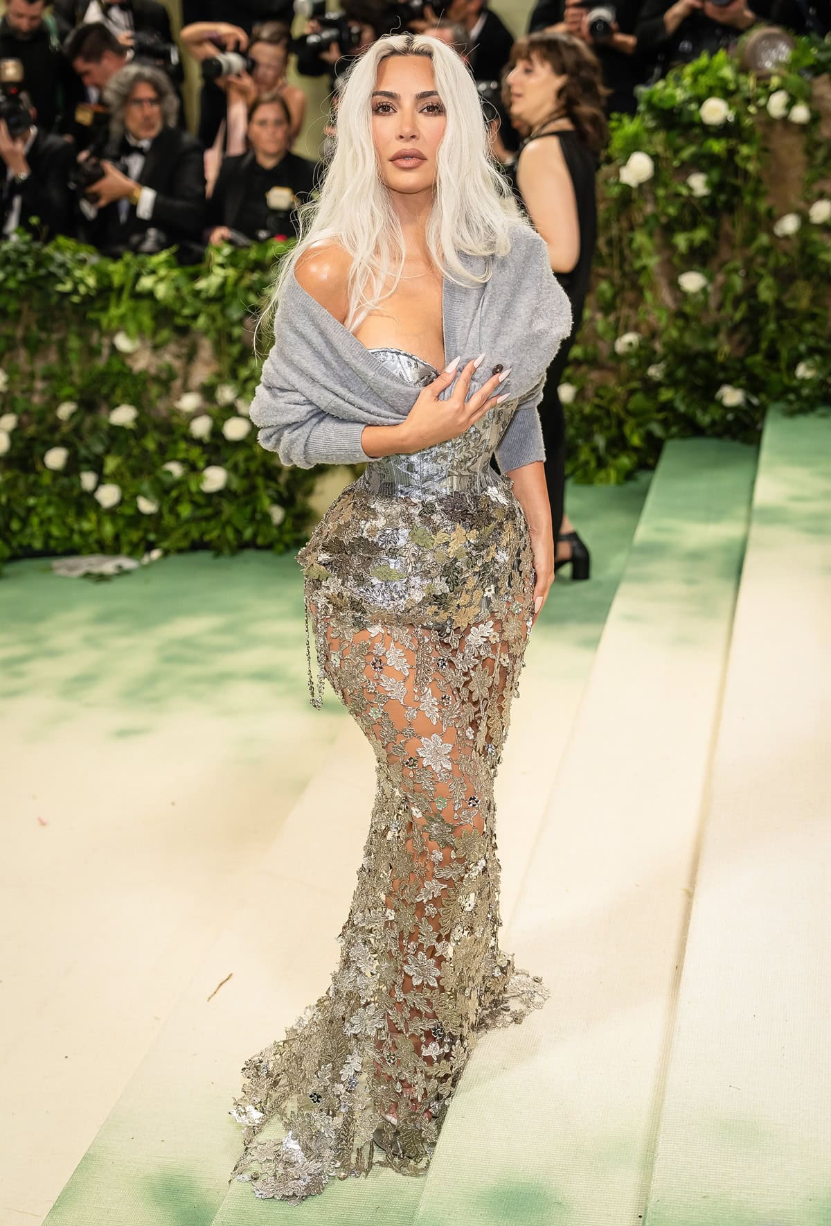 Kim Kardashian stuns in a Maison Margiela couture ensemble at the 2024 Met Gala, epitomizing the theme 'The Garden of Time' with a breathtaking, intricately designed silver floral chain-mail gown