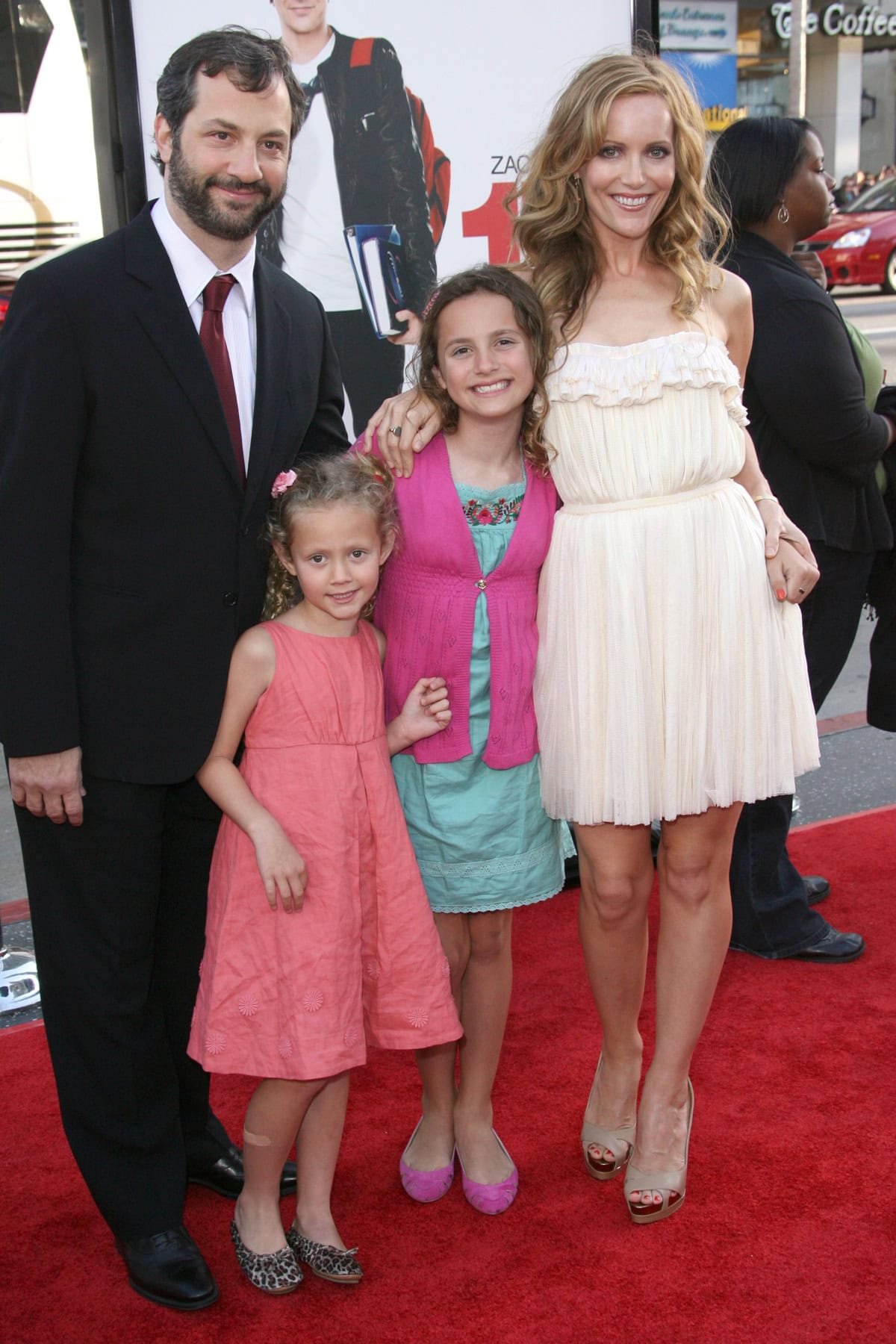 Leslie Mann stuns in a ruffled ivory Zac Posen dress and nude Christian Louboutin peep-toe heels at the 17 Again premiere, posing on the red carpet with husband Judd Apatow and their daughters