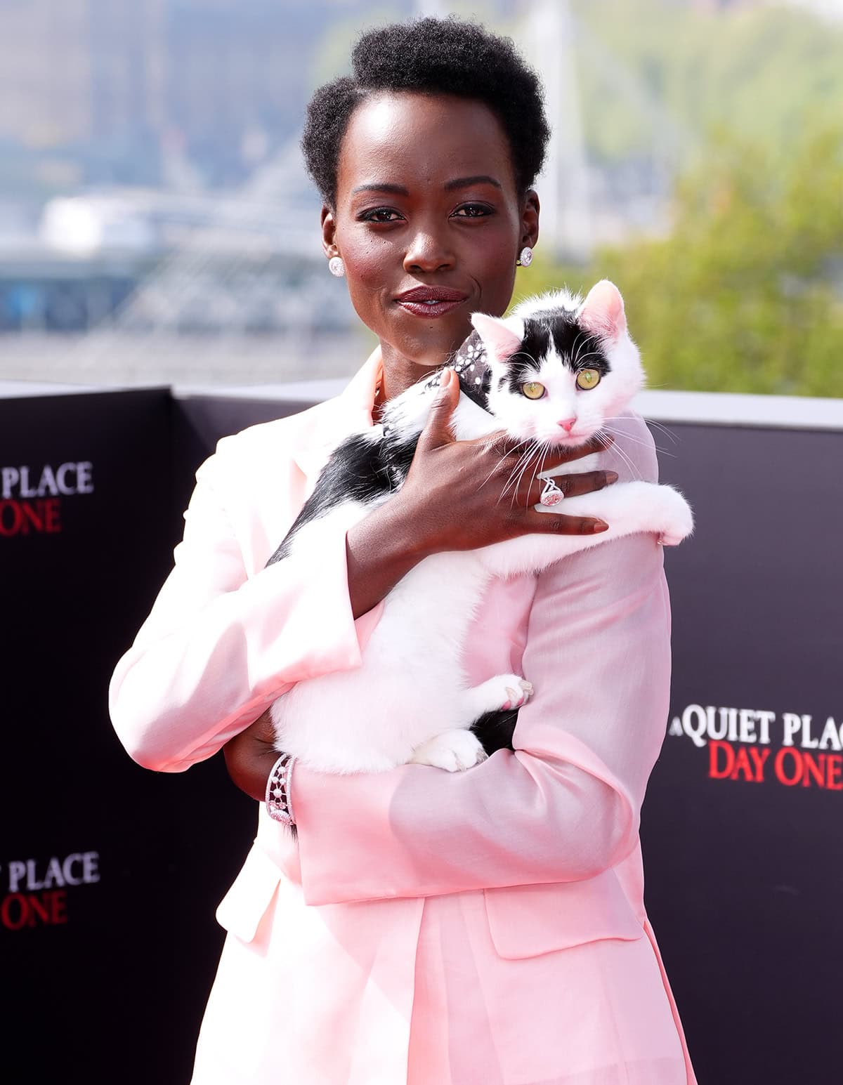 Lupita Nyong'o carrying her adorable furry accessory at the London photocall for A Quiet Place: Day One at the IET Building on May 1, 2024