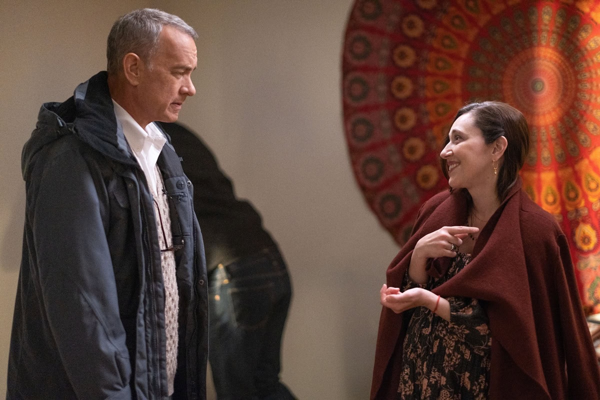 Radiating warmth and optimism, Mariana Treviño’s Marisol stands out in a flowy floral dress and rust shawl—her vibrant maternity style a striking contrast to Otto’s muted tones
