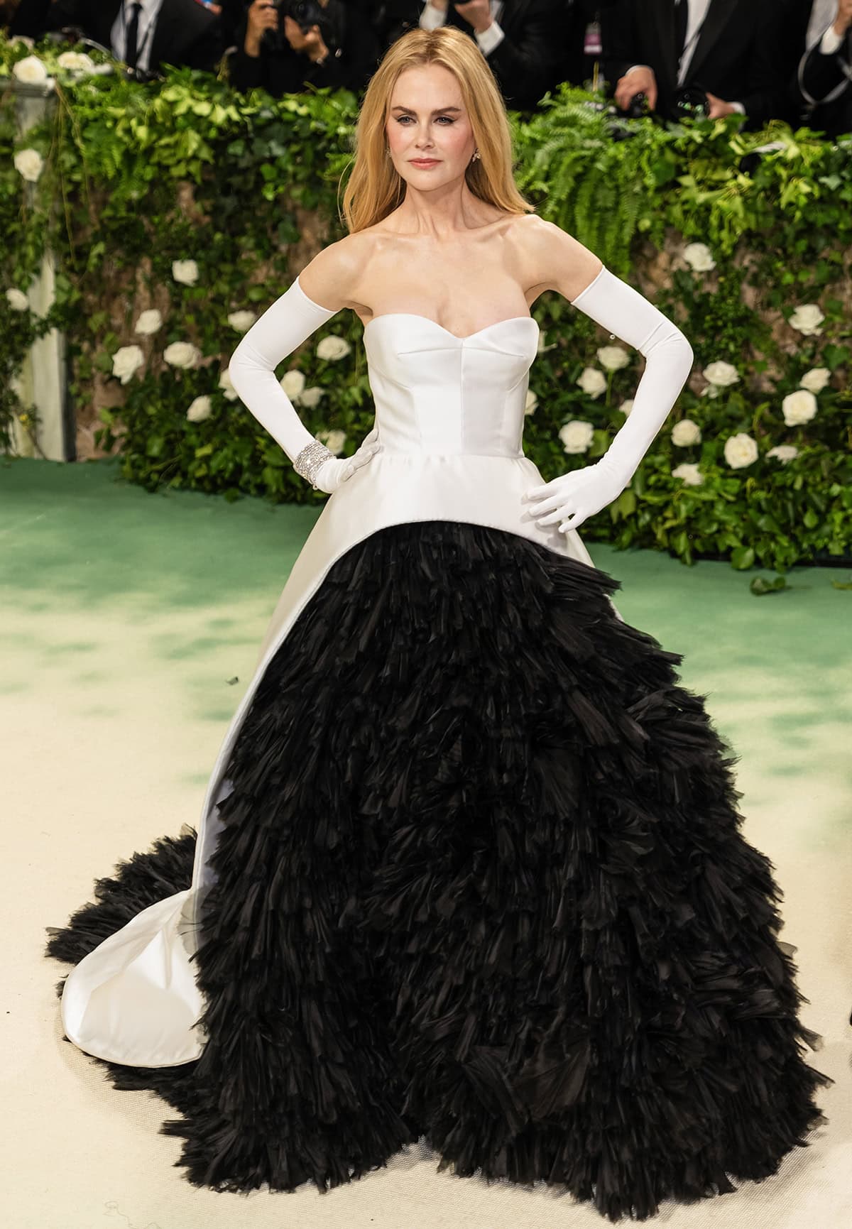 Nicole Kidman's black-and-white Met Gala gown features a white satin bustier top, cascading down her back and partially overlaying a black organza ruffle skirt