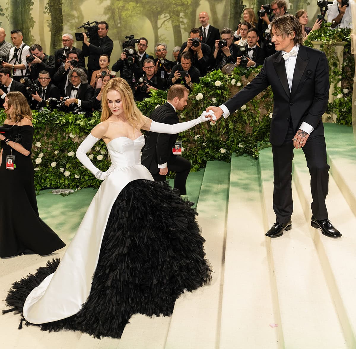 As they ascend the Met Gala stairs wearing matching black-and-white ensembles, Nicole Kidman appears like a princess being assisted by her prince charming husband Keith Urban