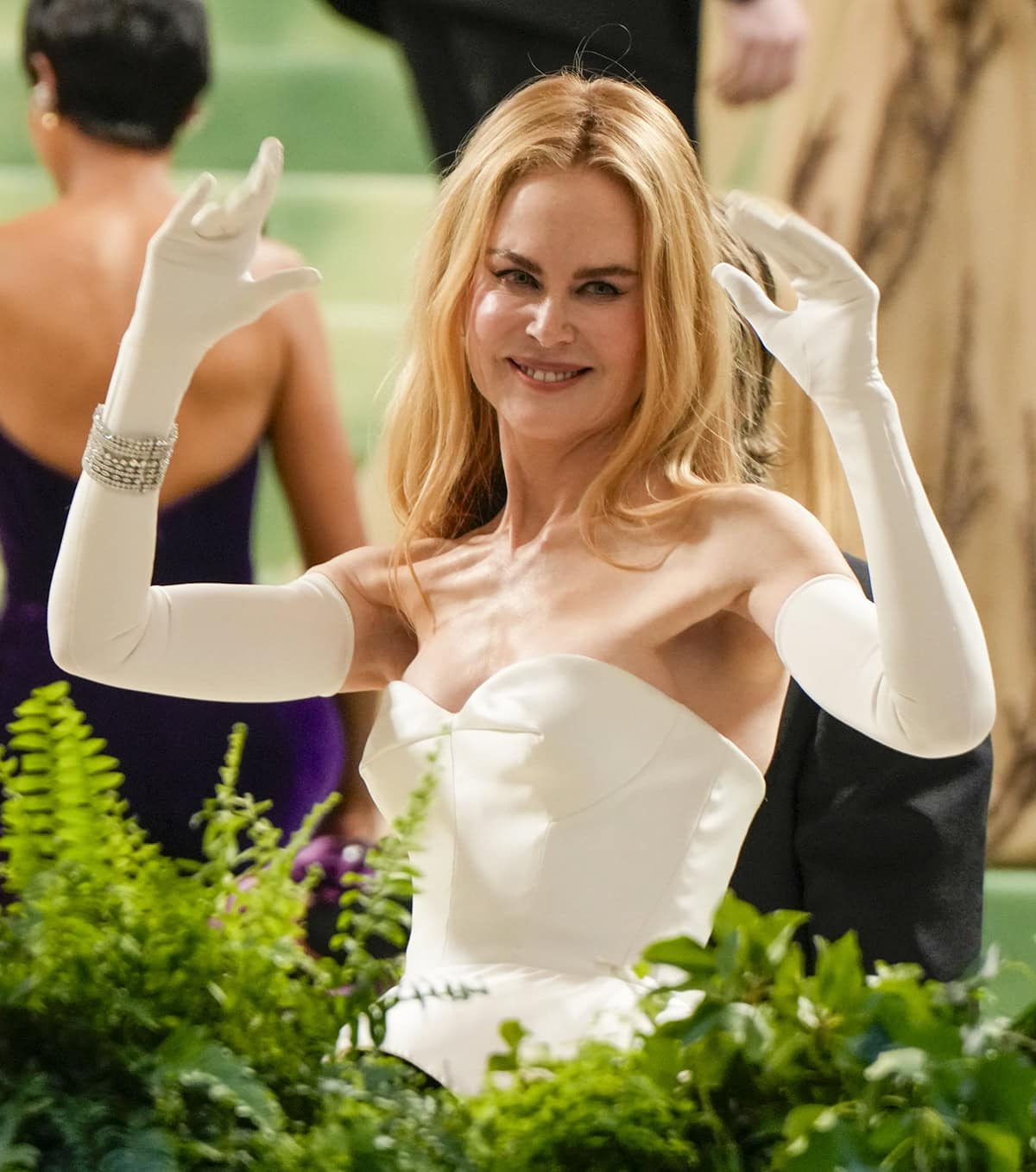 Nicole Kidman elegantly styles her Balenciaga gown with white opera gloves and jewelry by Harry Winston, including the Cluster Diamond Earrings and the Secret Combination Platinum and Diamond Bracelet