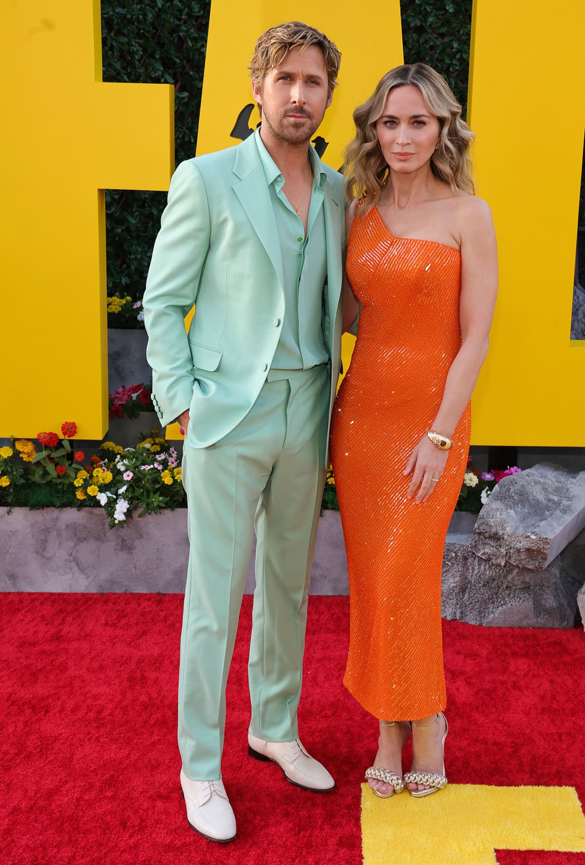 Ryan Gosling looks handsome in a custom mint green suit by Gucci with white loafers and a gold Tag Heuer watch