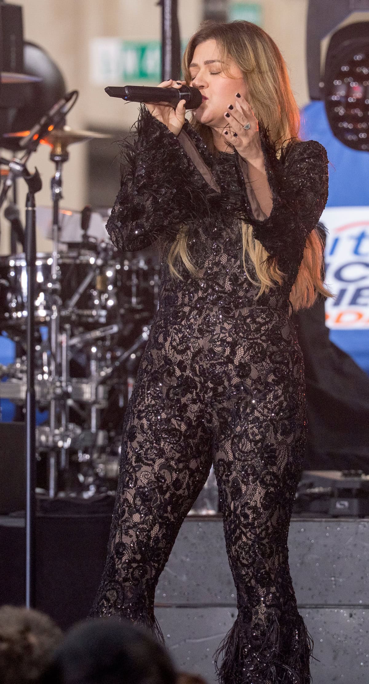 Kelly Clarkson dazzles in a sheer, sequin-embroidered lace jumpsuit with feathered cuffs as she kicks off the 2025 Citi Concert Series on the Today show at Rockefeller Plaza