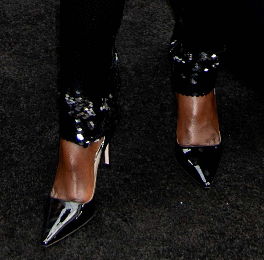 Lupita Nyong'o teams her sparkling sequin catsuit with glossy patent leather pumps