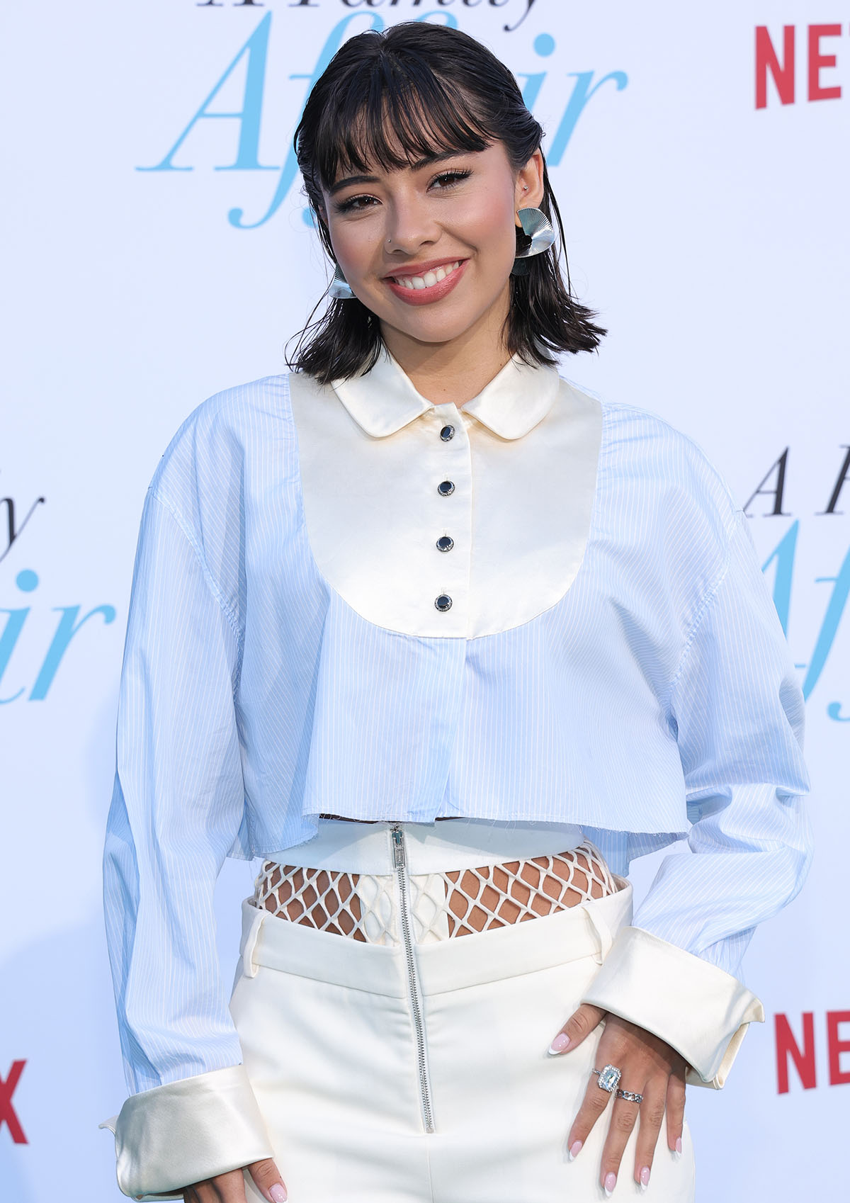Xochitl Gomez wears a wet-look half-up, half-down hairstyle and rosy pink makeup