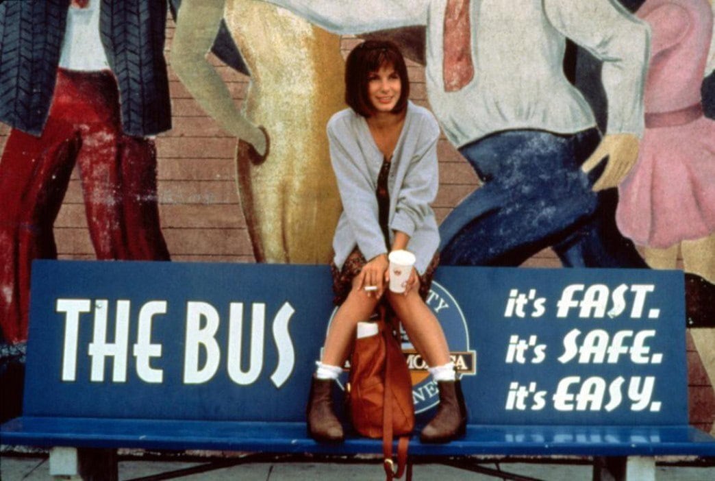 Wearing a slouchy cardigan over a printed dress with slouch socks and brown Chelsea boots, Sandra Bullock gave Annie a grounded, effortlessly cool style that perfectly suited her role as a reluctant hero on a runaway bus