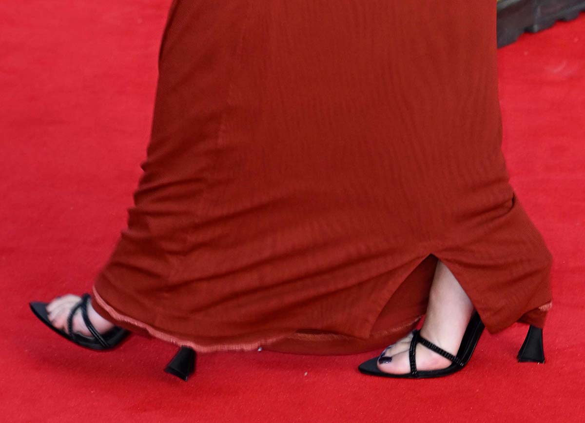 Scarlett Johansson teams her red dress with black Saint Laurent Liza sandals with crystal-encrusted straps, wraparound ankle straps, and geometric flared heels