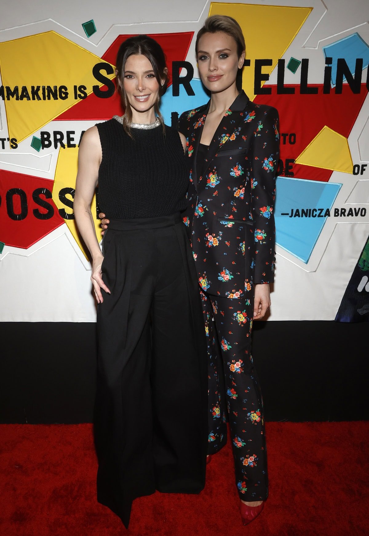 Ashley Greene looked chic in a sleeveless black knit top and wide-leg trousers, appearing noticeably shorter next to 5ft 8½ (174 cm) tall Wallis Day in a bold floral pantsuit at the 2023 WIF Oscar Party held at NeueHouse Los Angeles
