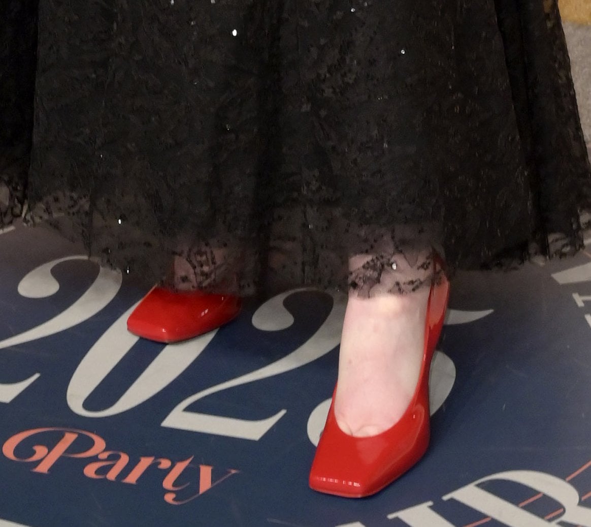 Elle Fanning stands out in her vibrant red pumps featuring a square toe and high heels