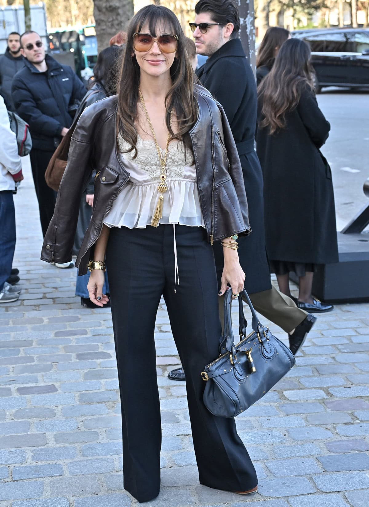 Rashida Jones exudes effortless Parisian chic at the Chloé show during Paris Fashion Week, pairing classic wide-leg trousers with understated heels for a refined finish on March 6, 2025