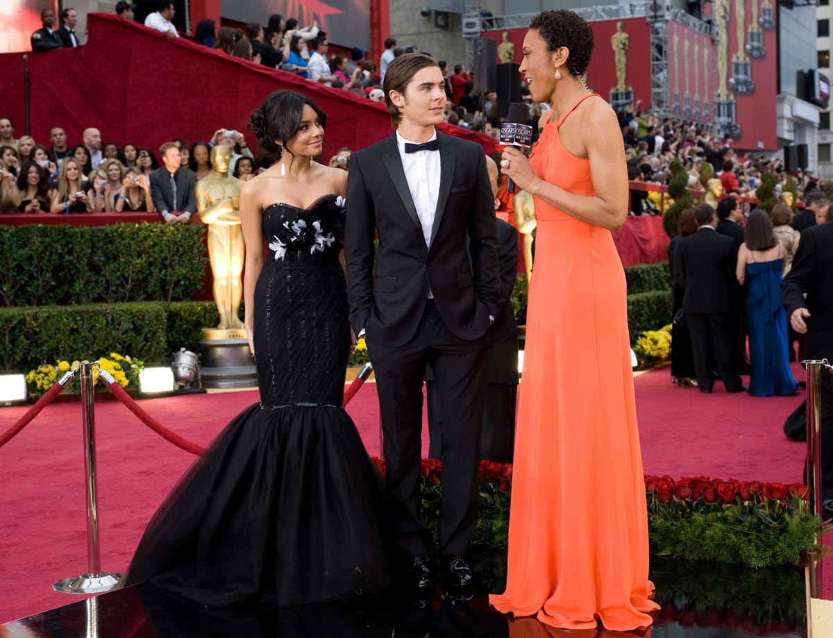 Vanessa Hudgens brought Old Hollywood glamour to the 2009 Oscars in a floral-embellished black Marchesa fishtail gown, pairing the dramatic silhouette with elegant heels that complemented Zac Efron's classic Dolce & Gabbana tuxedo and polished Bally shoes on February 22, 2009