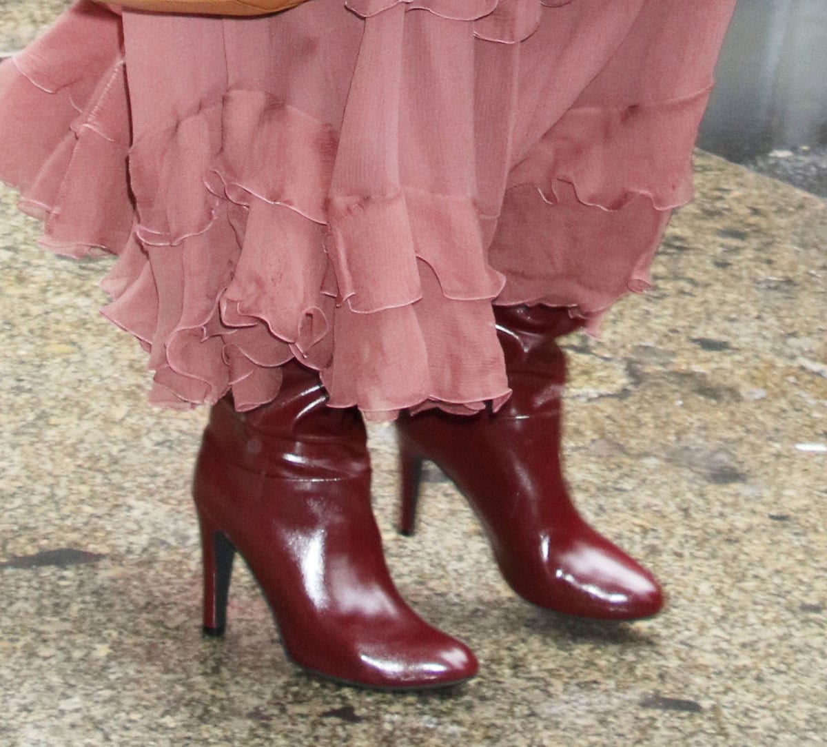 Heidi Klum pairs her pink chiffon dress with a burgundy fur coat and matching wine red Jeffrey Campbell boots