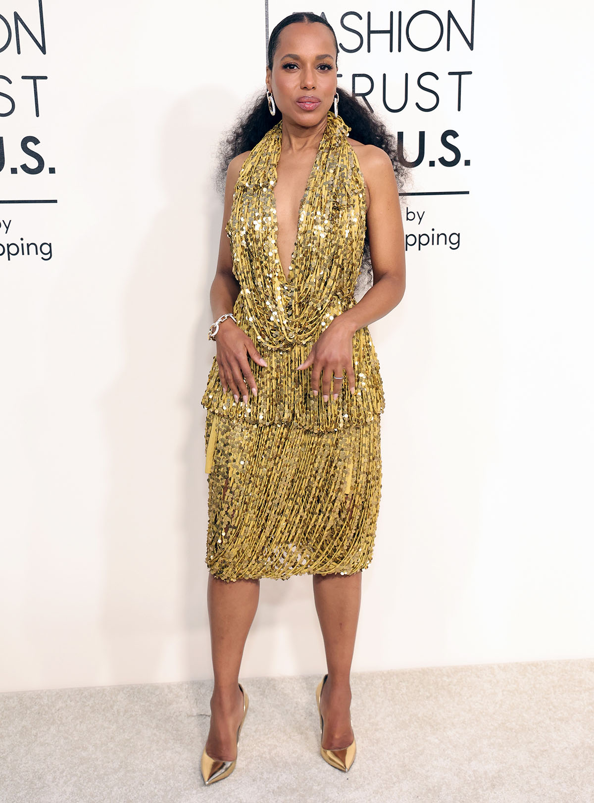 Kerry Washington channels the flapper era with her gold fringe plunging dress adorned with sparkling sequins