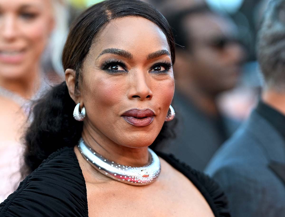 Angela Bassett styles her black ensemble with a thick silver necklace and matching earrings adorned with sparkling diamonds
