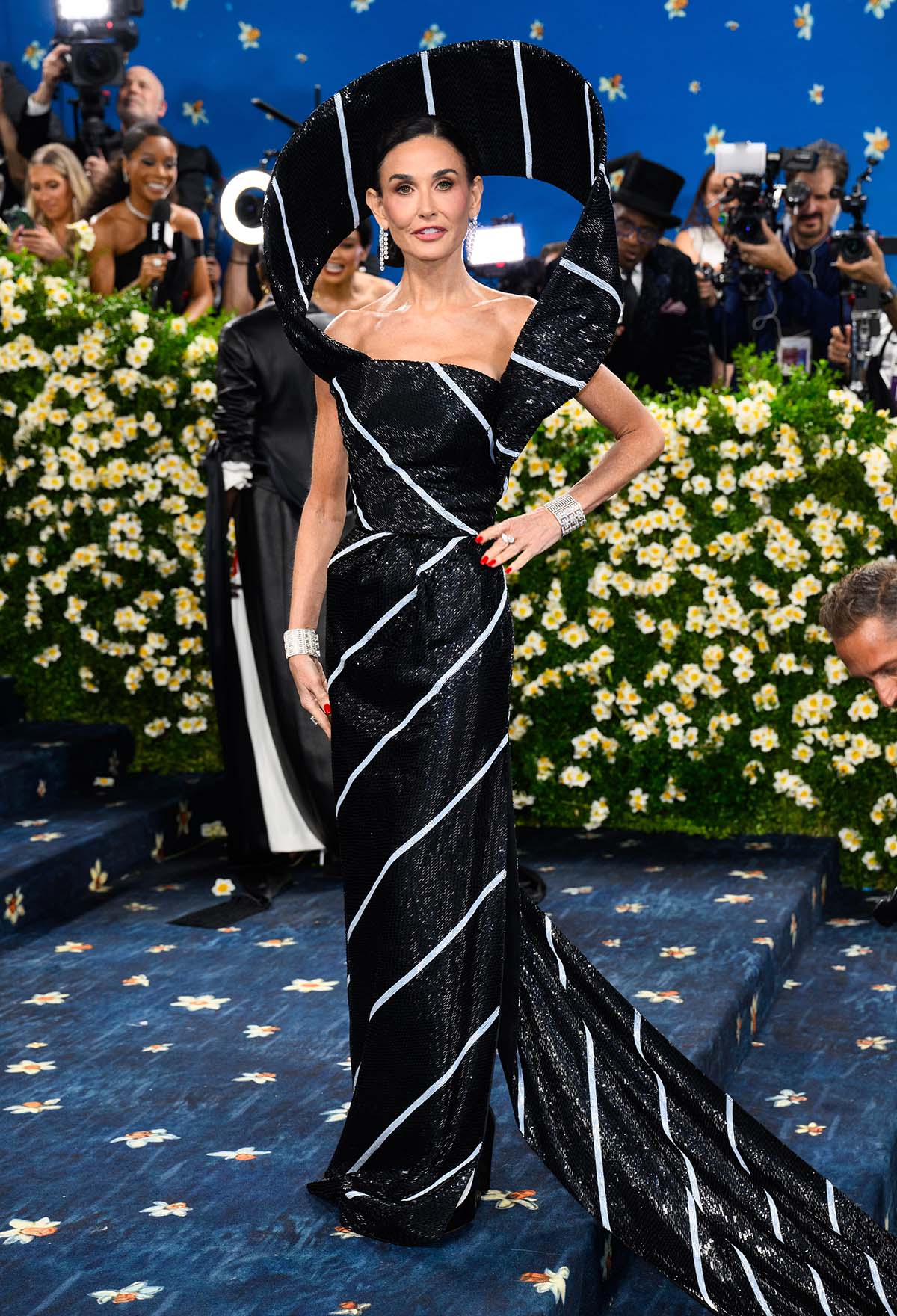 Demi Moore wears an architectural necktie gown by Thom Browne, embroidered with over 1,400,000 beads