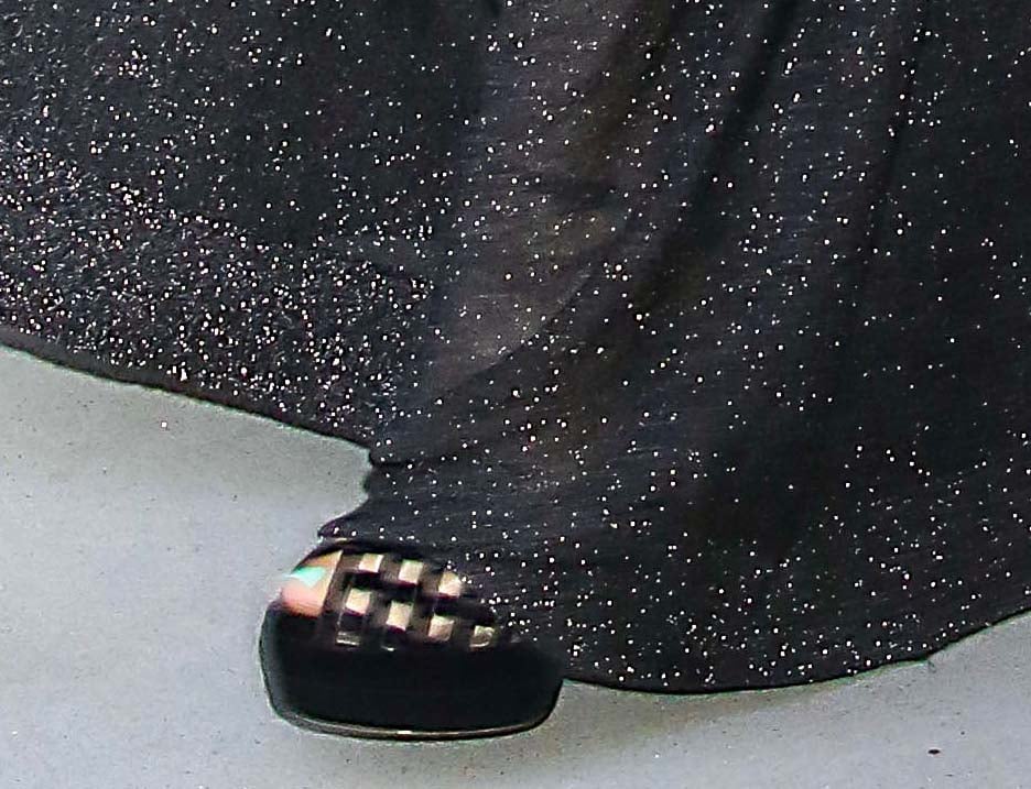Florence Pugh completes her head-to-toe black look with Aquazzura Romance Plateau sandals featuring mesh latticework paneling
