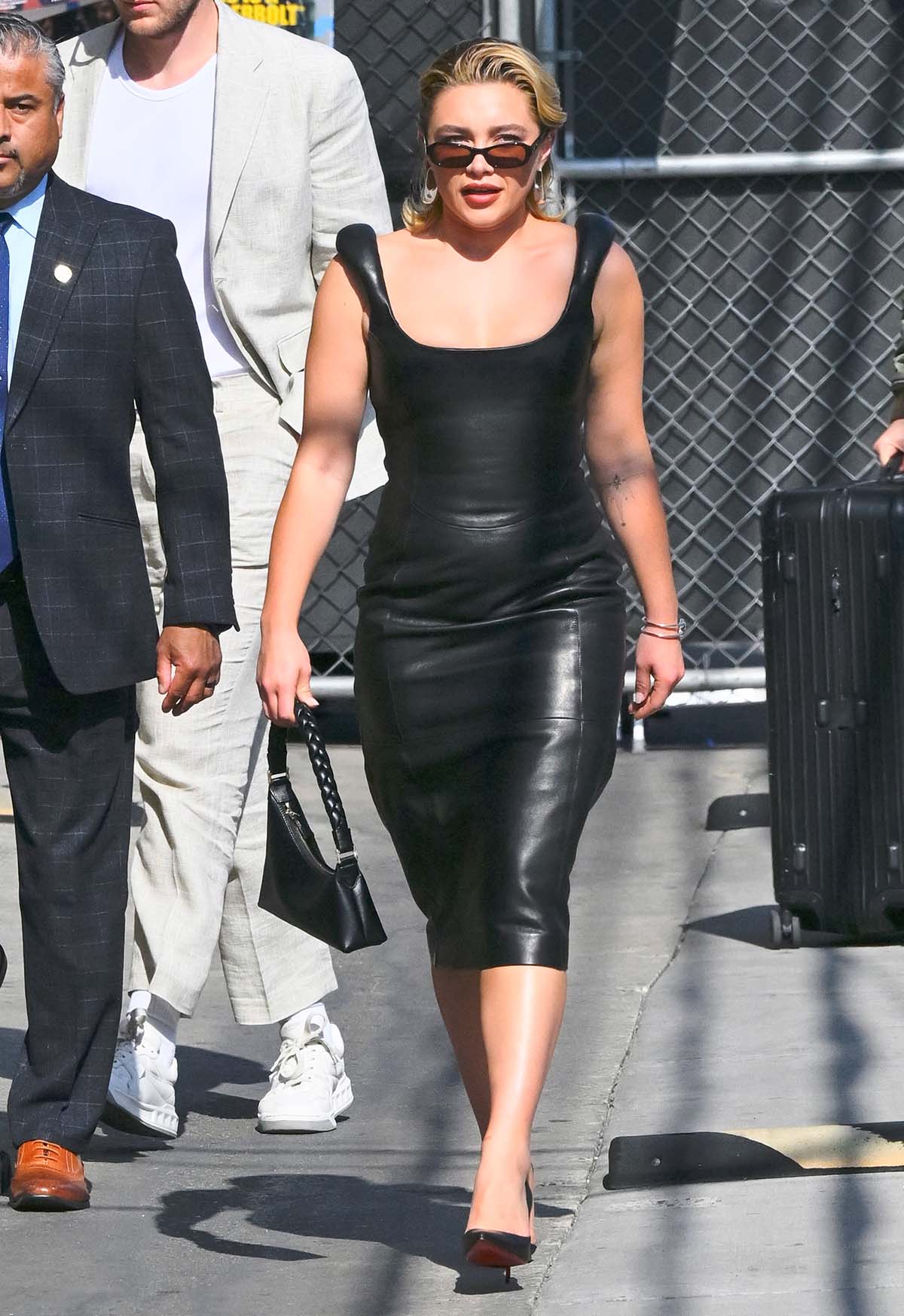 Florence Pugh visits Jimmy Kimmel Live! in a form-fitting black leather sleeveless dress with puffed shoulder straps by Marine Serre