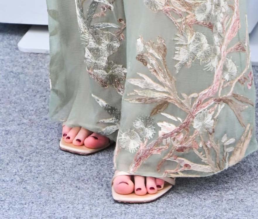 Jennifer Lawrence completes her boho ensemble with simple nude open-toe sandals by Christian Louboutin