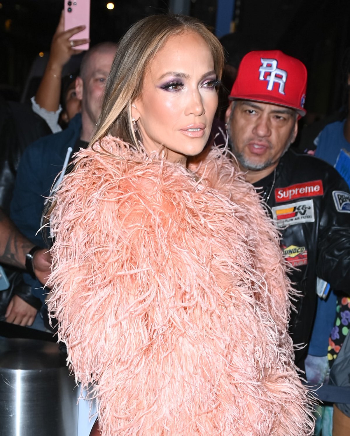 Jennifer Lopez enhances her look's allure with smokey purple eyeshadow and nude lipstick