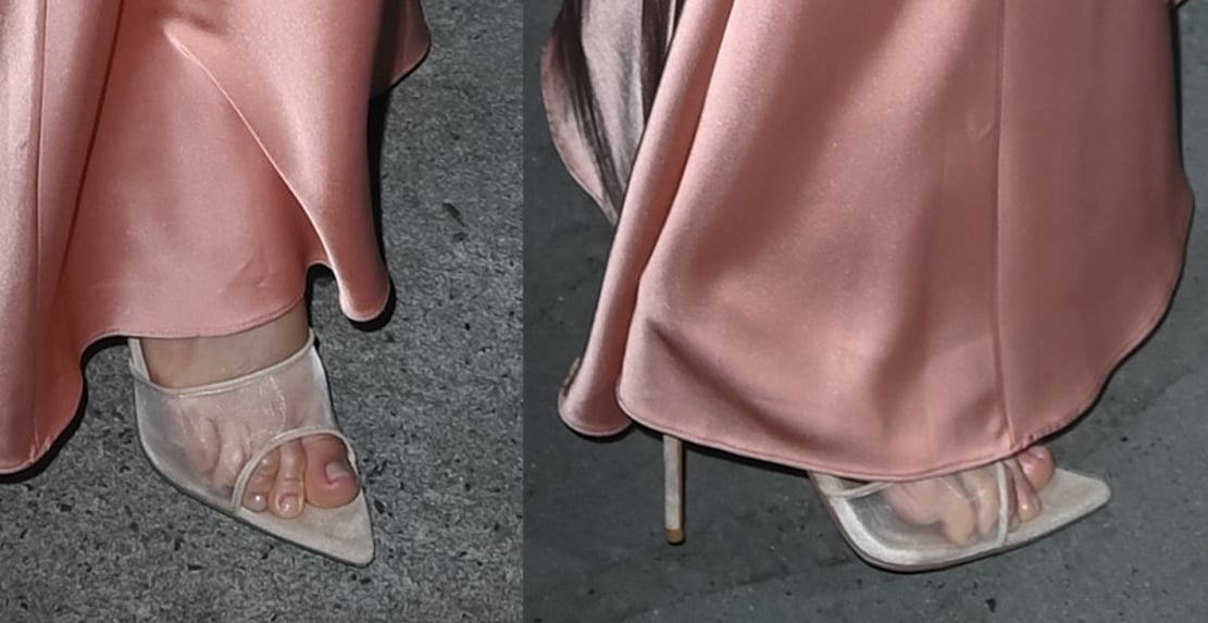 Jennifer Lopez pairs her salmon pink slip dress with white suede Femme LA mules with transparent toe straps, open pointed toes, and high stiletto heels
