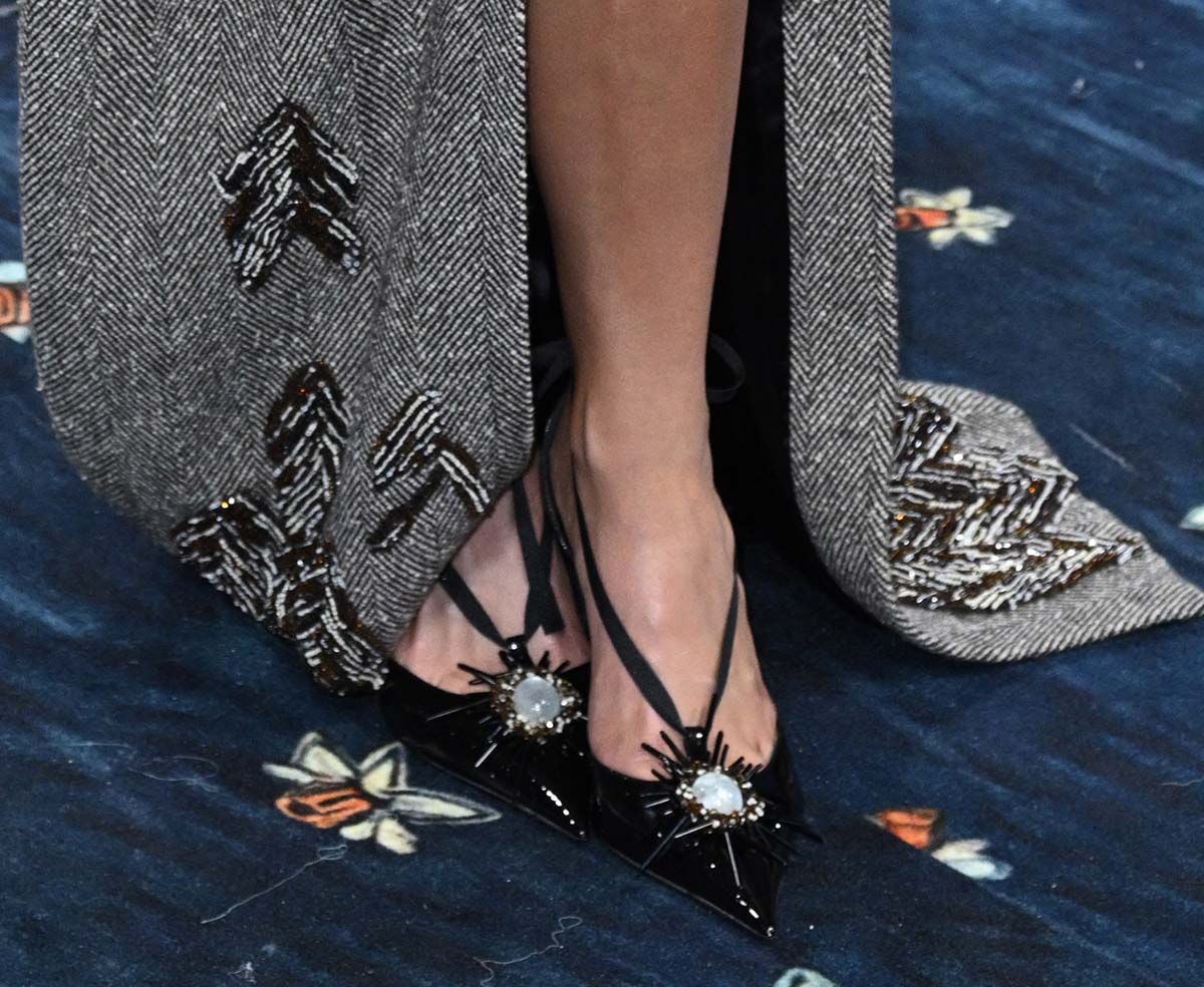 Kylie Jenner wows in shiny black Ferragamo pumps whimsically adorned with a gemstone flower embellishment set against a bed of beads