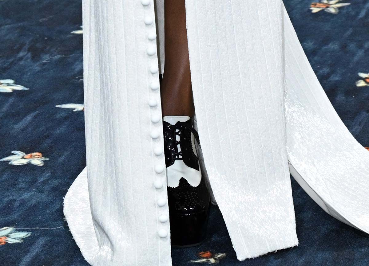 Zoe Saldana wears black and white Thom Browne Longwing Brogues with wingtips, lace ties, and perforations