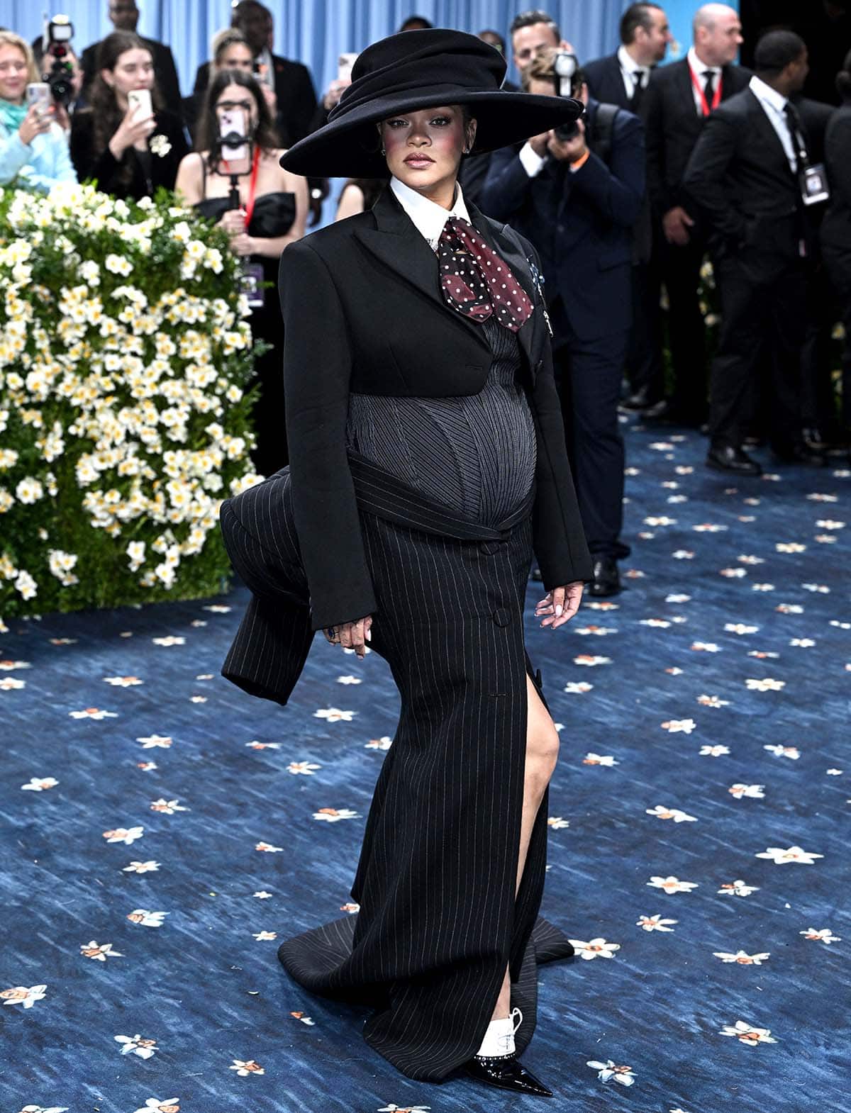Rihanna reveals 3rd pregnancy in a Marc Jacobs corset bodysuit, a cropped blazer, and a tuxedo-style pinstriped maxi skirt