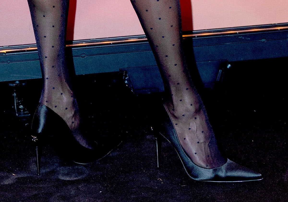 Nicole Ari Parker adds a touch of playful element to her sleek look with polka-dot tights, finished with sleek black pointed-toe stiletto pumps
