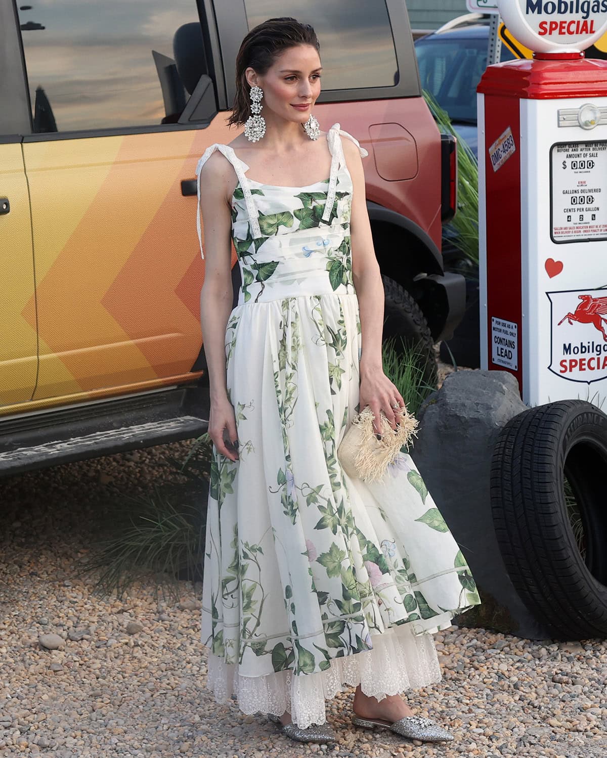 Olivia Palermo embraces summer elegance in a white silk cotton organza dress with green ivy prints, lace trims, and shoulder ties by Alice + Olivia