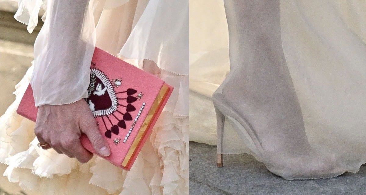 Diane Kruger adds a pop of color to her dreamy look with a pink Olympia Le-Tan book-shaped clutch and completes her ensemble with open-toe stiletto mules
