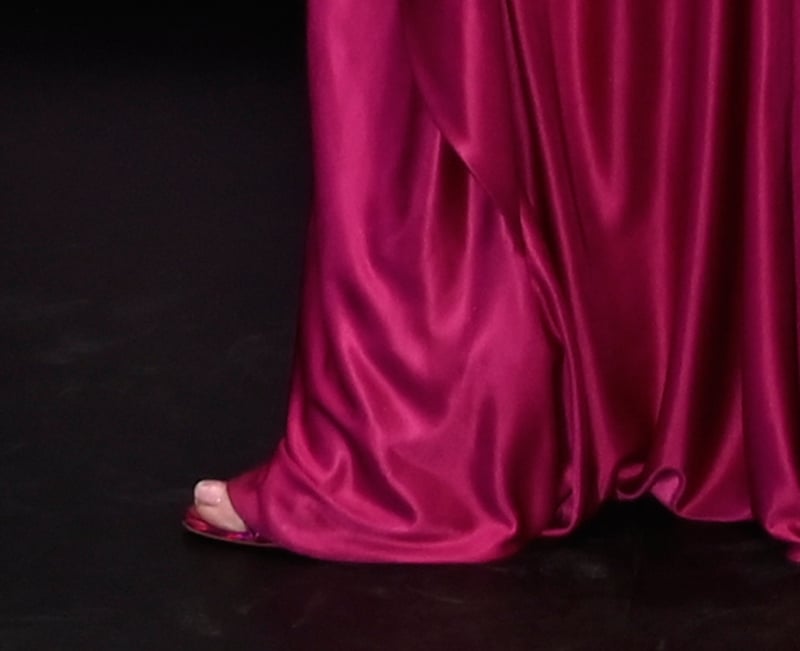 Lindsay Lohan brings full glamour to the Mexico premiere of Freakier Friday, wearing iridescent pink Christian Louboutin Loubigirl sandals