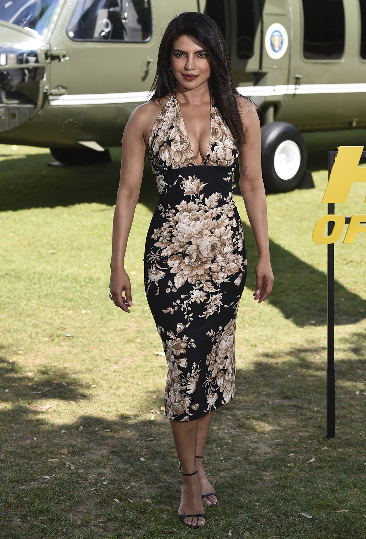 Priyanka Chopra showcases her signature feminine style in a floral halter dress by Dolce & Gabbana at the Heads of State London photocall at Potters Fields Park