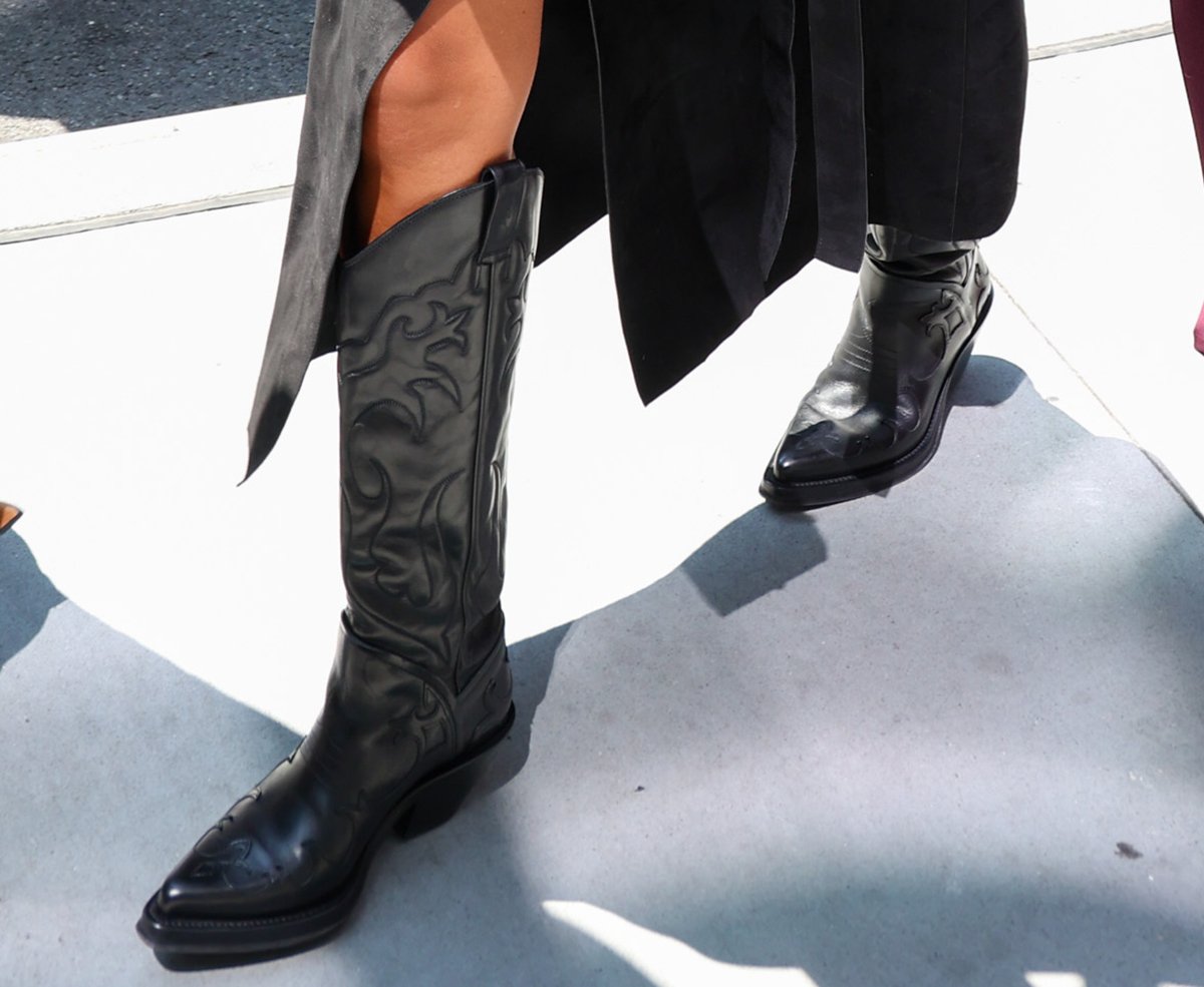 Jessica Alba adds drama to her sleek ensemble with the Gabriela Hearst Capitana cowboy boots featuring flame-inspired western embroideries, snipped toes, and short block heels