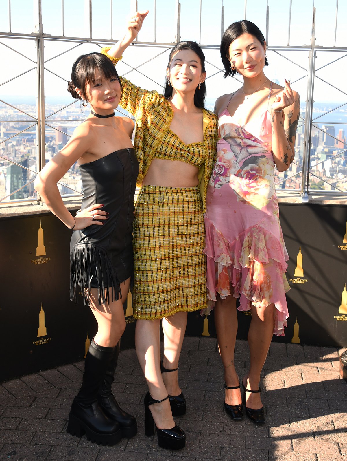 Rei Ami, Arden Cho, and May Hong, the voices behind KPop Demon Hunters' girl group Huntr/x, light the Empire State Building to kick off the KPop Demon Hunters Golden Weekend
