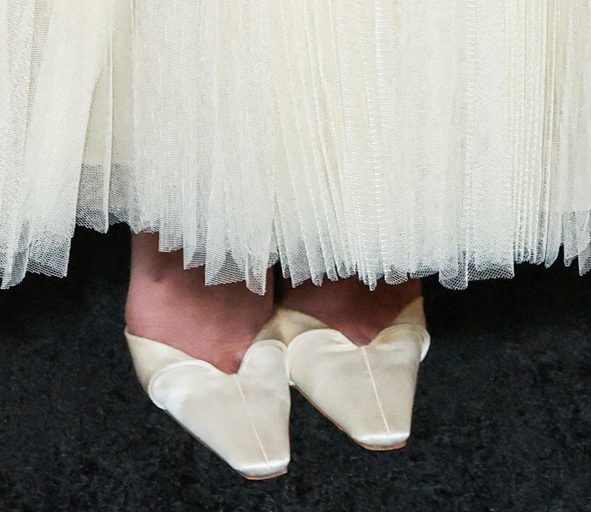 Sydney Sweeney completes her bridal ensemble with white satin Danielle Frankel Kennedy pumps featuring folded vamps, square toes, and high heels