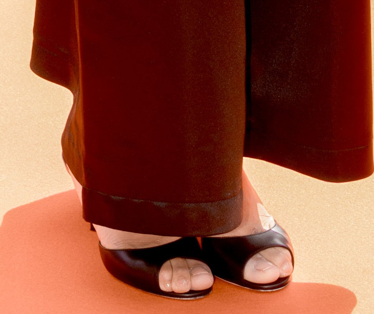Zoe Kravitz teams her laid-back summer ensemble with black peep-toe Manolo Blahnik Jada mules for a hint of understated luxury