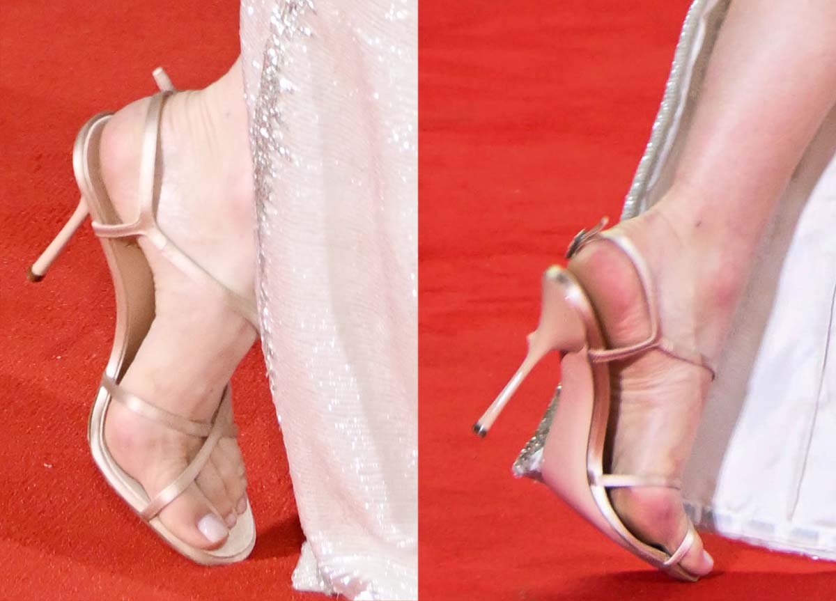 Emma Stone teams her ivory sequined gown with custom nude satin Louis Vuitton sandals featuring crisscrossing front straps and a diagonal strap across the vamps