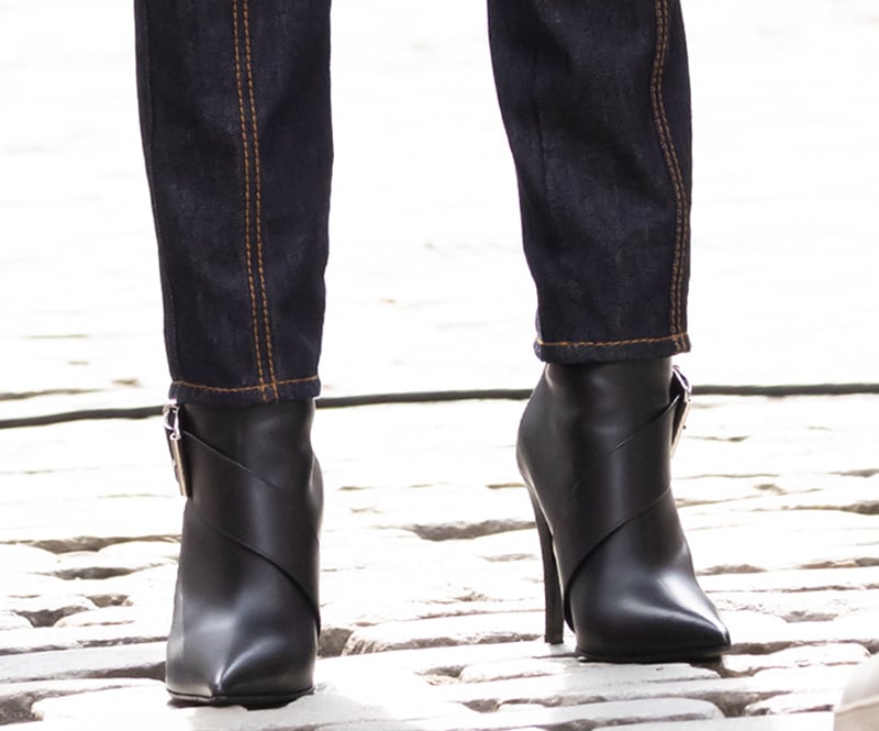Gigi Hadid completes her futuristic denim look with McQueen buckled leather ankle boots with sharp pointed toes and high heels