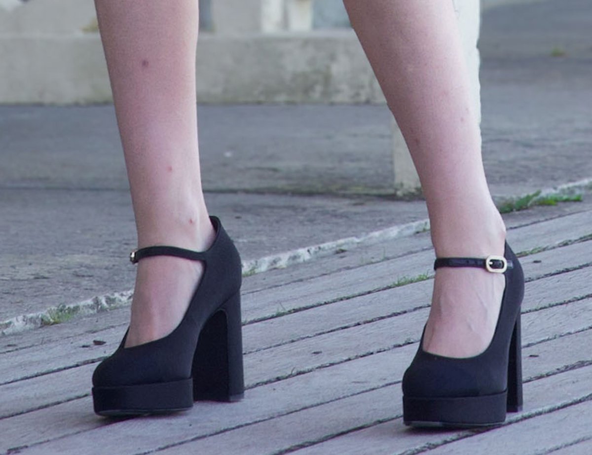 Kristen Stewart adds contrast to the soft white ensemble by slipping into a pair of black Chanel lambskin leather platform pumps