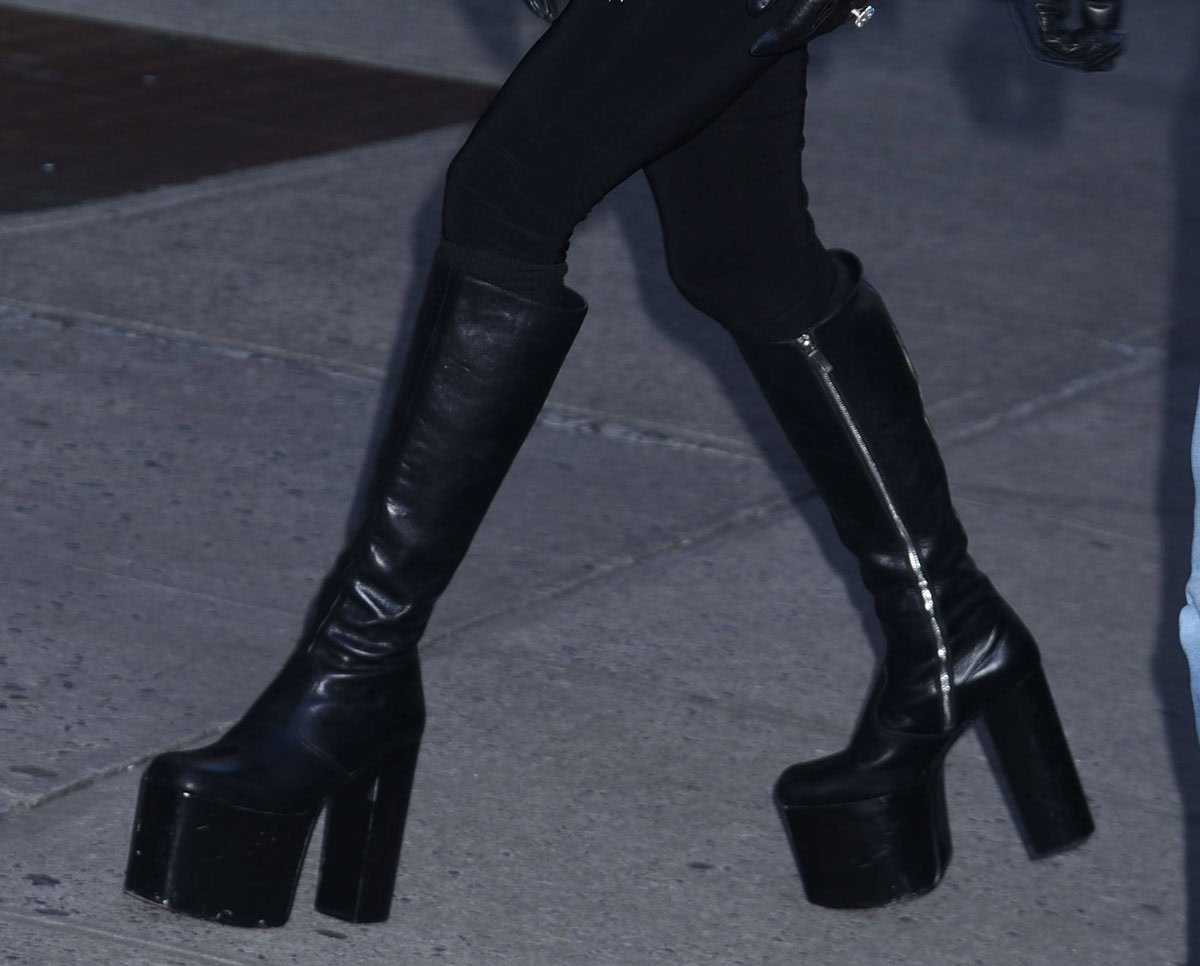 Lady Gaga completes her sleek look with her signature platform boots by Enfants Riches Déprimes, featuring towering wooden platforms and block heels