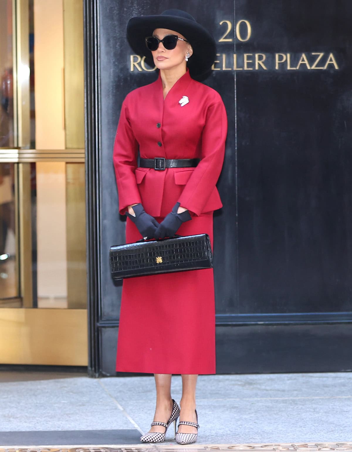 Jennifer Lopez commands attention in a fiery red virgin wool and silk grain de poudre Dior jacket and a matching red virgin wool-cotton-blend boucle midi skirt