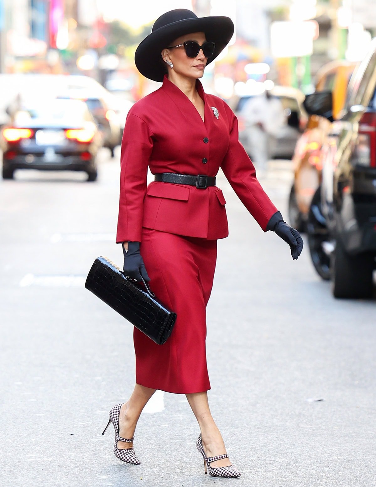 Jennifer Lopez on the set of her upcoming film, The Last Mrs. Parrish, looking striking and powerful in a red Dior skirt suit and Manolo Blahnik pumps