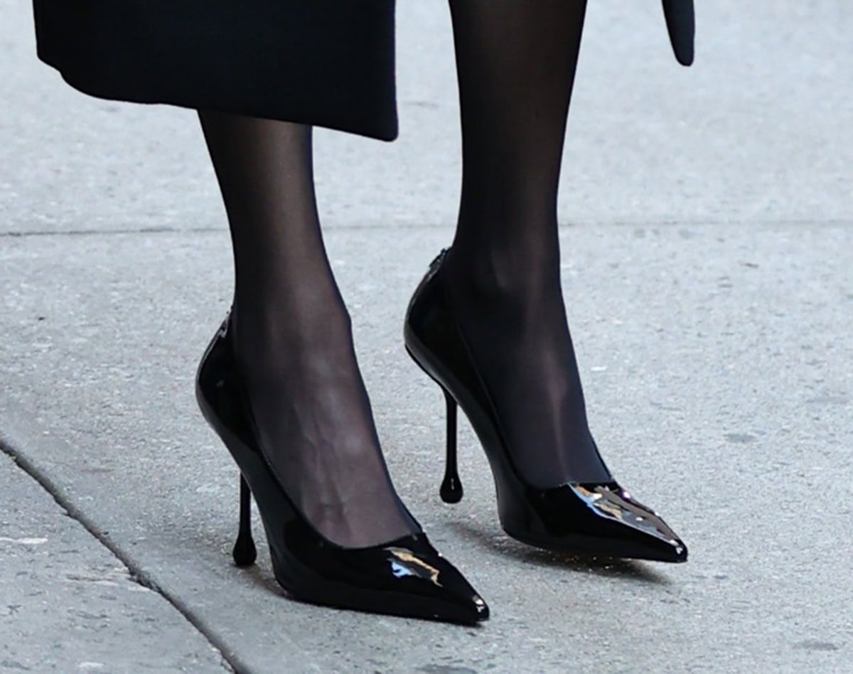 Julia Roberts finishes her fall ensemble with sheer black tights and glossy Jimmy Choo “Ixia” pumps, distinguished by their sleek pointed toes and sculptural drop-shaped stiletto heels